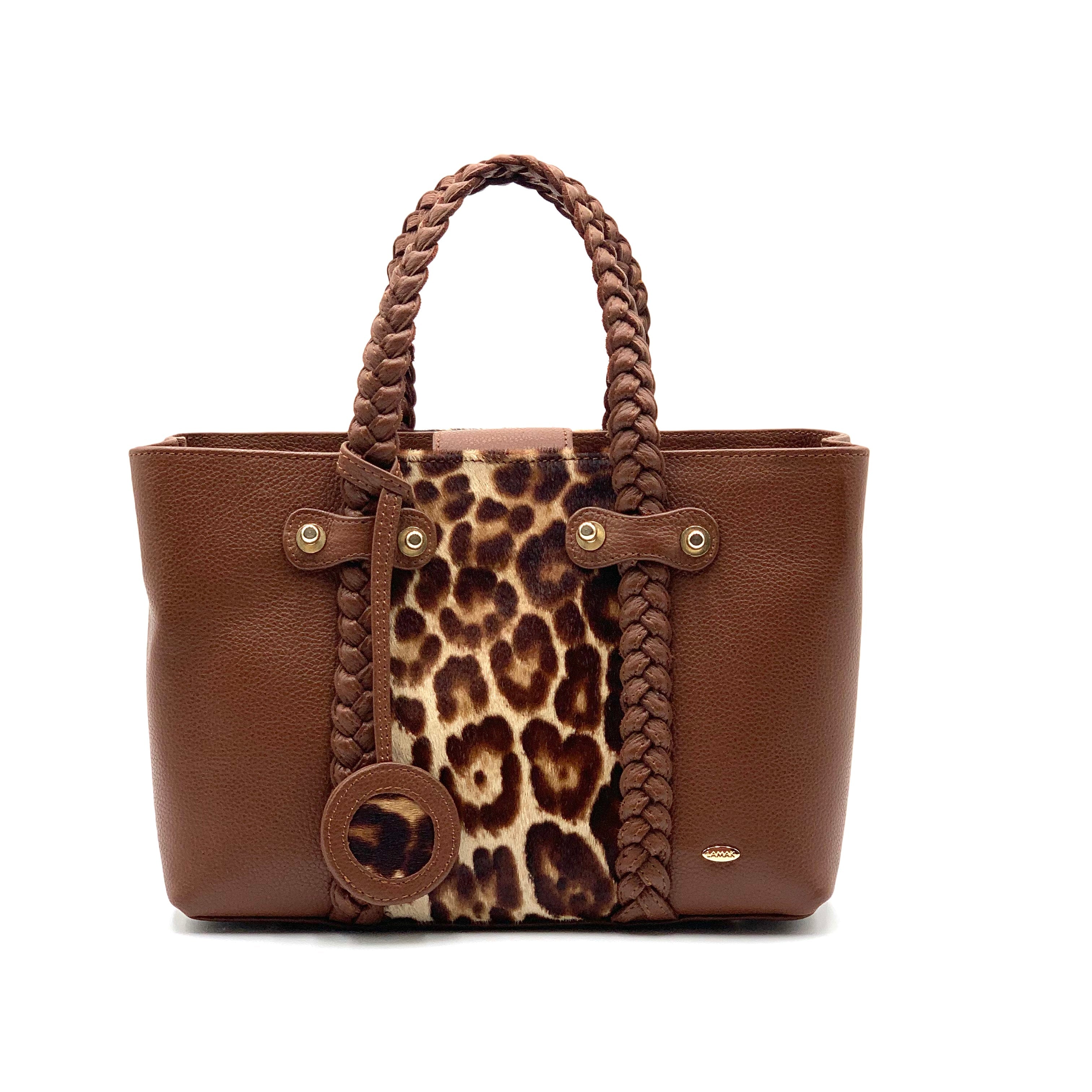 A brown leather tote bag with a leopard print pocket and braided handles.